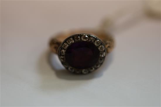 A George III gold, foil backed amethyst and diamond set oval ring, size L.